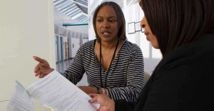 Employee Explaining Documents to Patient