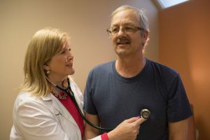 Doctor Checking Patient's Heartbeat with Stethoscope