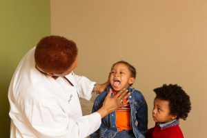 Doctor Inspecting Child's Throat