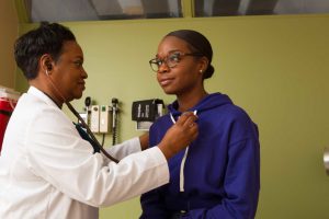 Doctor About To Check Patient's Heart With Stethoscope