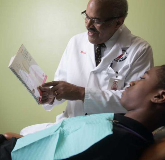 Doctor Reviewing Medical Diagram With Patient